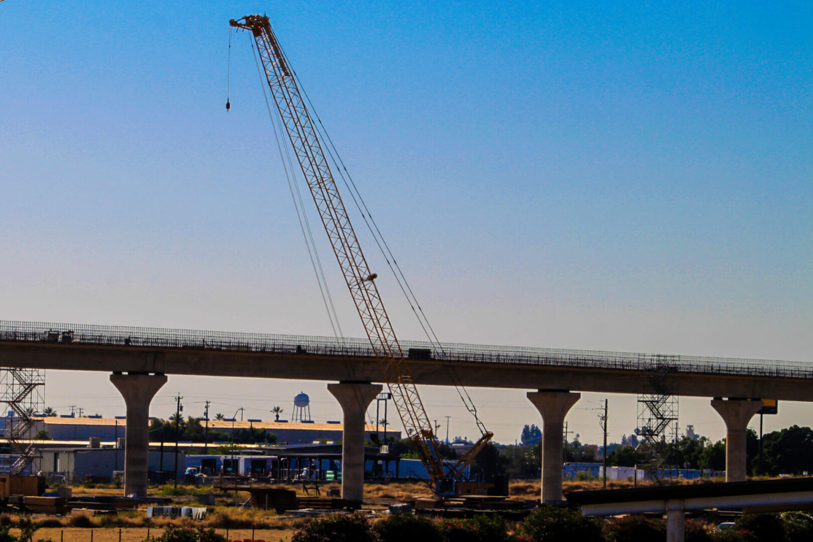Elevated highway under construction with crane